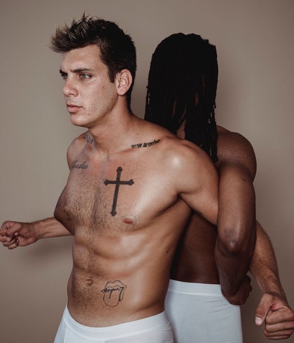 Man performing a controlled bodyweight exercise in a spacious, modern studio.