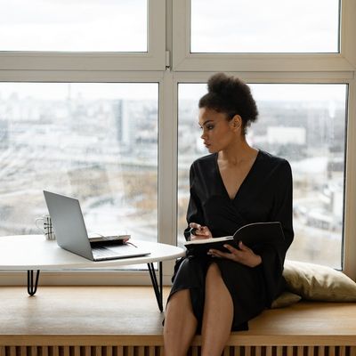 View from a window showing a calm morning cityscape.
